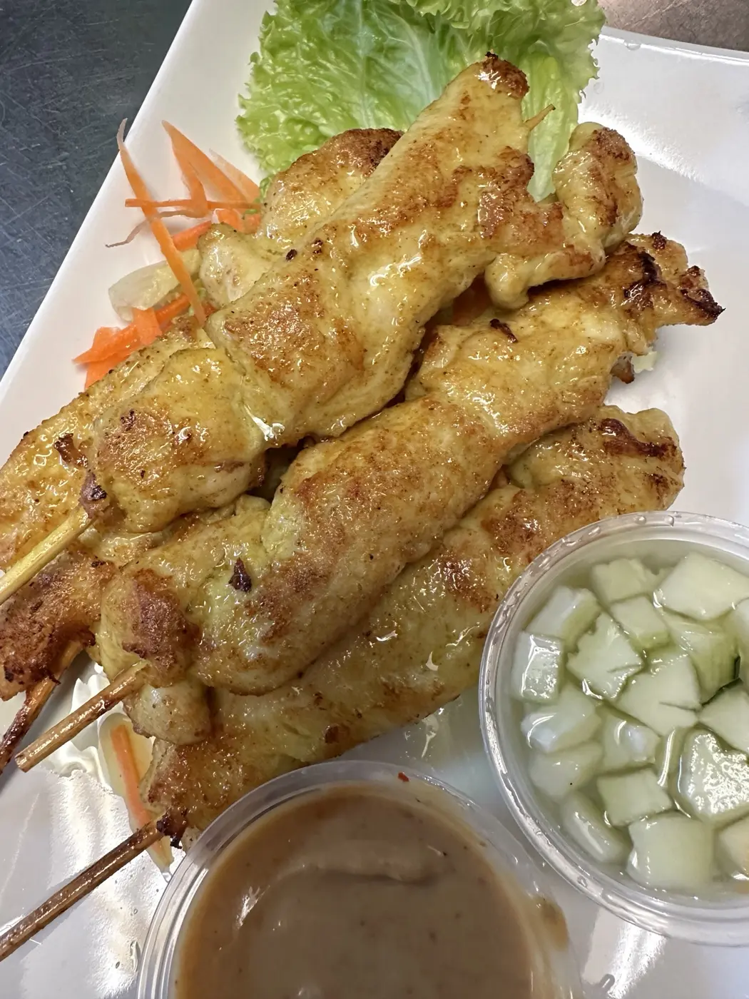 Grilled chicken satay with peanut sauce and cucumber relish